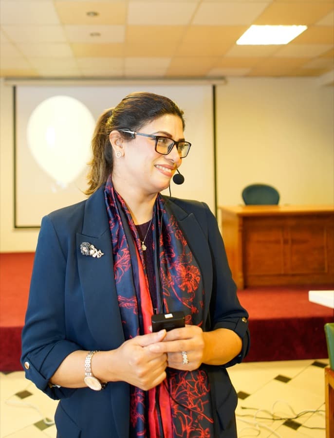 Noushin Paracha speaking with a headset mic