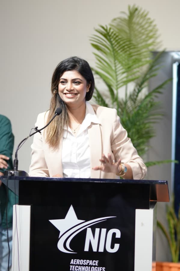Noushin Paracha speaking at a podium